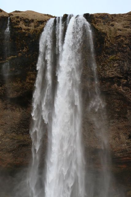 Powerful Waterfall Cascading from Cliff - Download Free Stock Photos Pikwizard.com