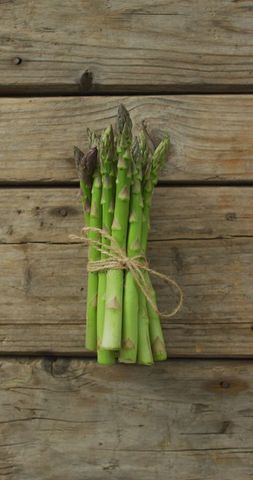 Bunch of fresh asparagus on rustic wooden table