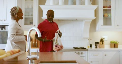 Happy Senior Couple Enjoying Time in Modern Kitchen