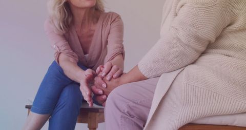 Senior Female Friends Comforting Each Other at Home