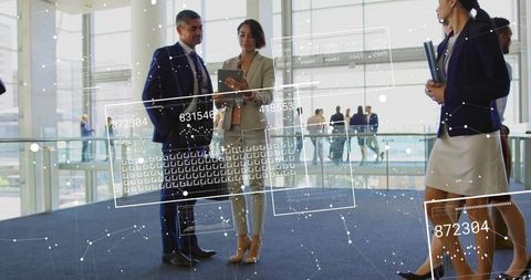 Business Professionals Discussing with Digital Data Overlay in Modern Lobby