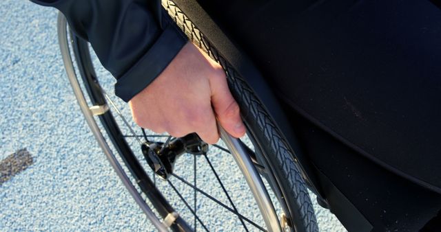 Close-Up of Person's Hand on Wheelchair Rim in Motion - Download Free Stock Images Pikwizard.com