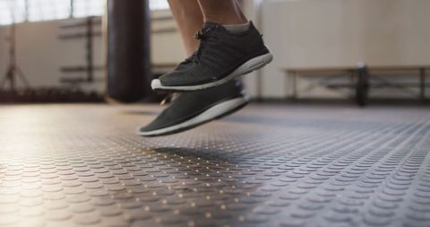 Close-Up of Athletic Man Jumping Rope in Fitness Gym