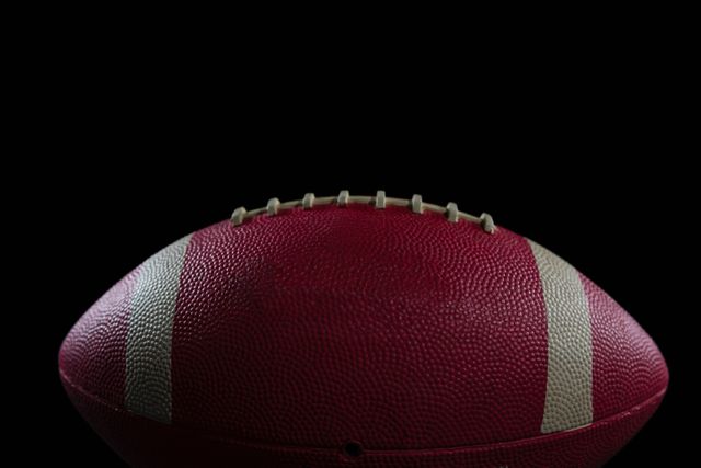 Close-up of American football against black background
