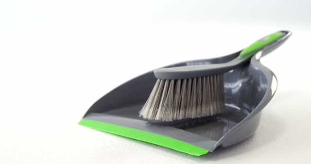 Close-Up of Grey Dustpan and Brush Set on White Background - Download Free Stock Images Pikwizard.com