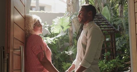 Romantic Couple Embracing and Smiling in Sunny Garden