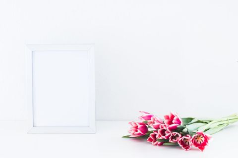 Minimalist white frame and bunch of pink tulips
