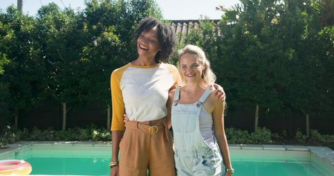 Diverse Friends Enjoying Sunny Day by Backyard Pool