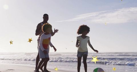 Family Fun on Beach with Inflatable Ball and Stars on Beach