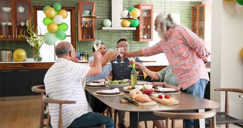Senior Diverse Friends Celebrating with Toast at Home