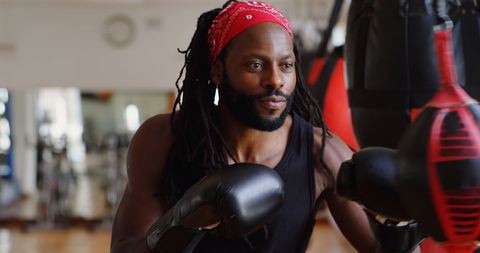 African American Male Boxer Training in Gym with Focus