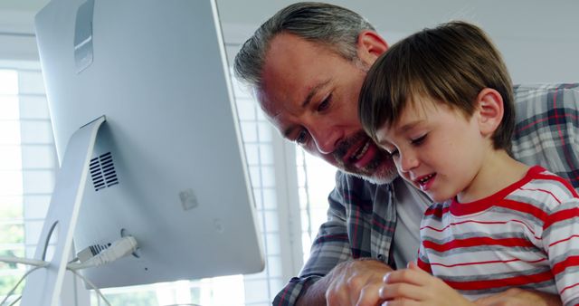 Father and Son Using Computer Together at Home - Download Free Stock Images Pikwizard.com