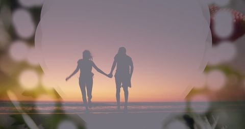 Romantic couple running on beach at sunset peaceful scenery