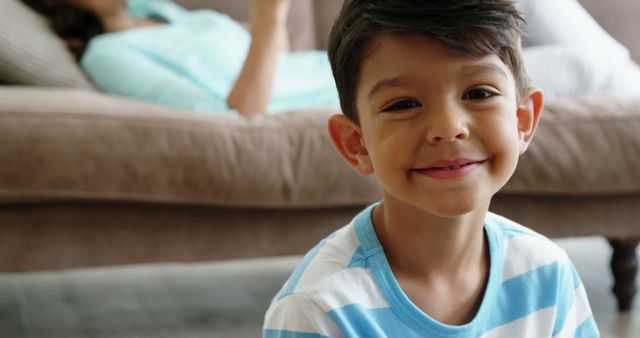 Happy Latin Boy Smiling Indoors with Adult in Background - Download Free Stock Images Pikwizard.com