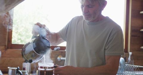Senior Man Brewing Coffee in Cozy Home Kitchen