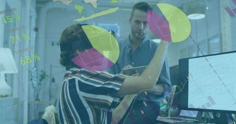 Woman using augmented reality presenting interactive pie charts on office glass for team analytics