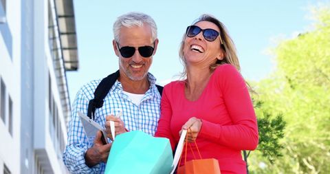 Joyful Mature Couple Shopping Under Sunny Sky - Download Free Stock Images Pikwizard.com