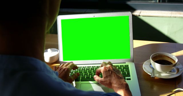 Person Working on Laptop with Green Screen at Coffee Shop - Download Free Stock Images Pikwizard.com