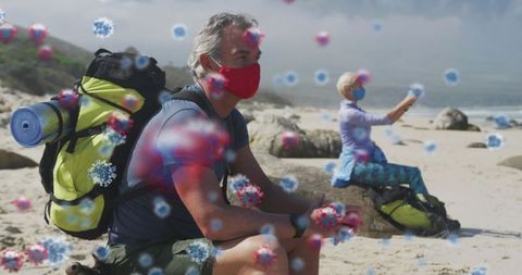 Senior Adventure with Virus Particles Digitally Overlaid on Beach