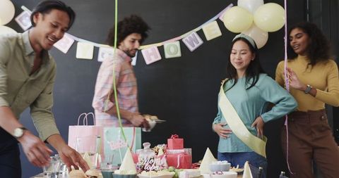 Colleagues Celebrating Baby Shower with Decorations and Food