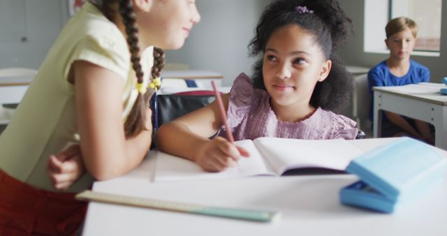 Girls with diverse backgrounds collaborating at school, engaged in learning activities. Perfect for educational content, teamwork concepts, school-related articles, and promotional materials for educational tools.