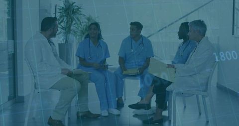 Medical Team Collaboration Meeting in Hospital Corridor