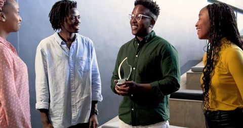 Colleagues Collaborating on Stairs in Modern Office Environment