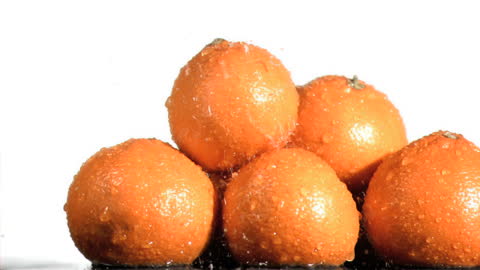 Fresh Oranges Soaked in Water with Splash Effects