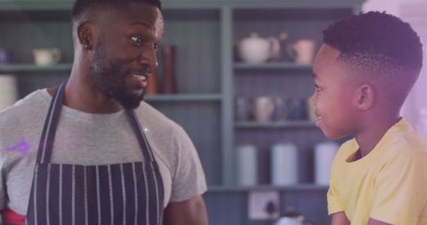 Father and Son Bonding in Kitchen with Joyful Cooking