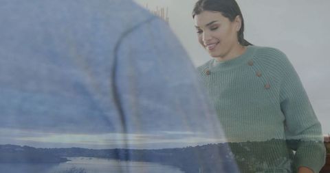 Smiling woman in modern interior with natural reflection