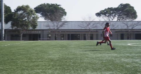 Focused soccer player running during training session