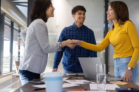 Diverse Coworkers Shaking Hands in Modern Office