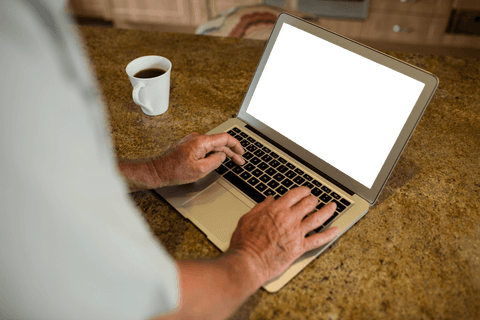 Senior Man Using Laptop in Modern Kitchen with Transparent Screen - Download Free Stock Videos Pikwizard.com