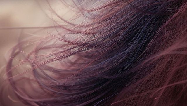 Close-up of flowing pink and purple hair in warm light