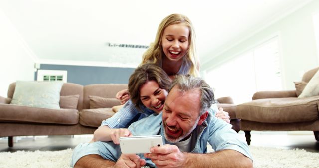 Happy family enjoy time together laughing at videos on smartphone - Download Free Stock Images Pikwizard.com