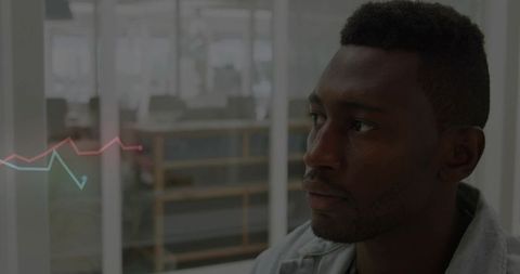 Business analyst watching digital graph at modern office