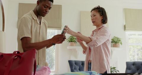 Couple collaborating to organize clothes at home