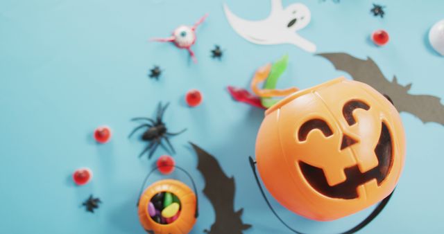 Close up view of multiple halloween toys and candies against blue background. halloween festivity and celebration concept