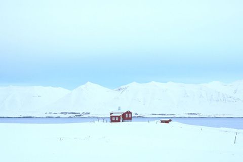 Solitary Red Cabin in Pristine Snowy Landscape
