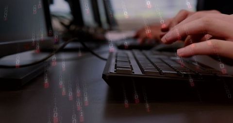 Hands Typing on Slim Keyboard with Floating Binary Code Overlay on Desktop Workstation