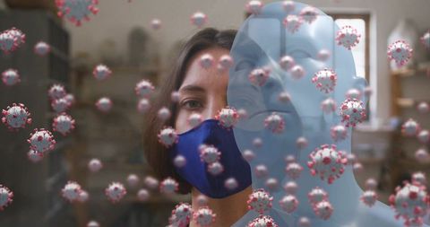 Woman in blue face mask surrounded by floating coronavirus particles and transparent bust