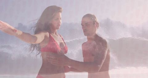 Couple Embracing at Ocean's Edge in Beach Swimwear