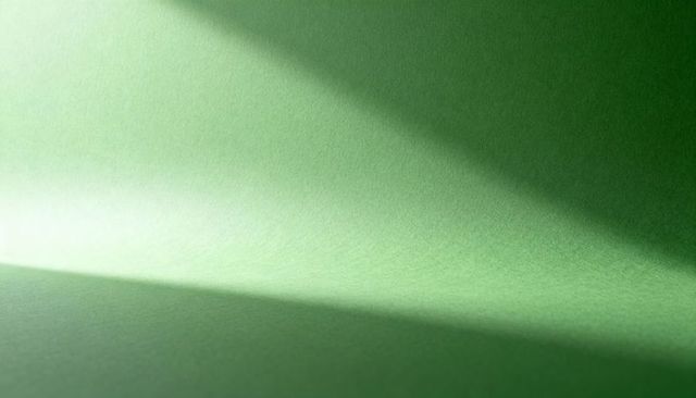 Green Curved Paper Revealing Diagonal Shadow and Soft Textured Gradient for Background