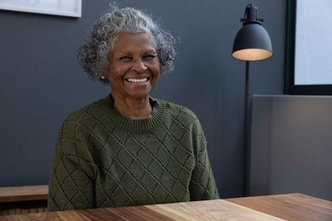Senior woman smiling in cozy home environment