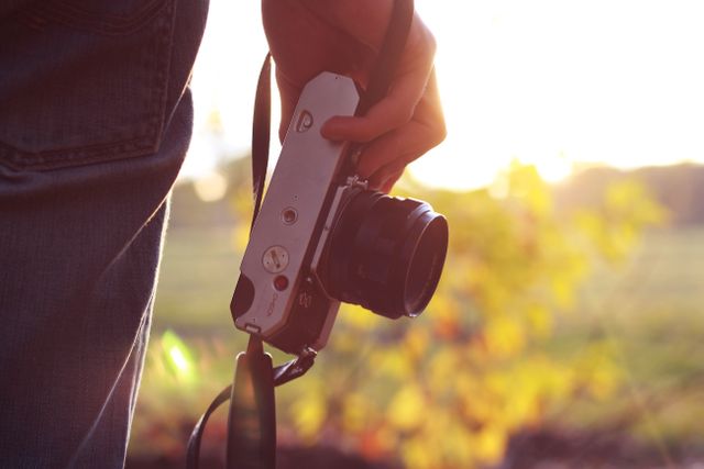 Close-up of Person Holding Vintage Camera in Sunset Light - Download Free Stock Photos Pikwizard.com