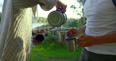 Couple Enjoying Outdoor Coffee in Nature Setting