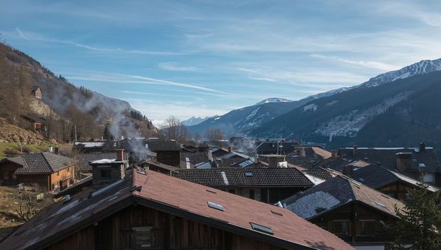 Steaming chalets in winter valley with snow-capped peaks, skylights and rustic chimneys