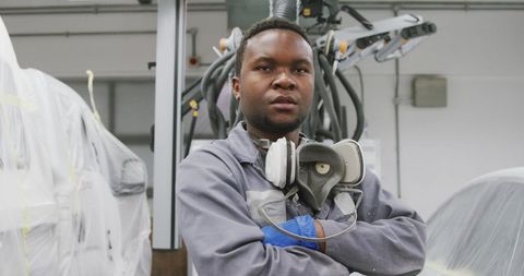 Confident Car Mechanic in Modern Auto Workshop