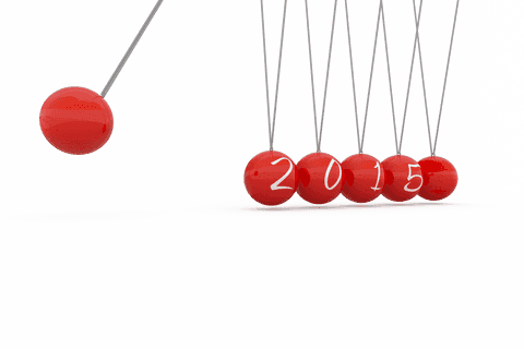 Transparent newton's cradle with red balls and 2015 motion