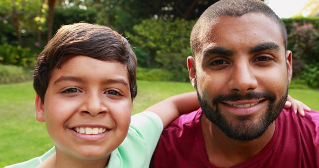 Father and Son Smiling in Garden on Sunny Day - Download Free Stock Images Pikwizard.com